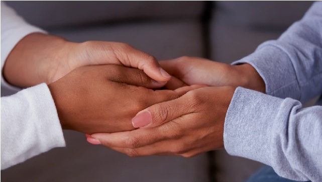 Mother holding son's hands